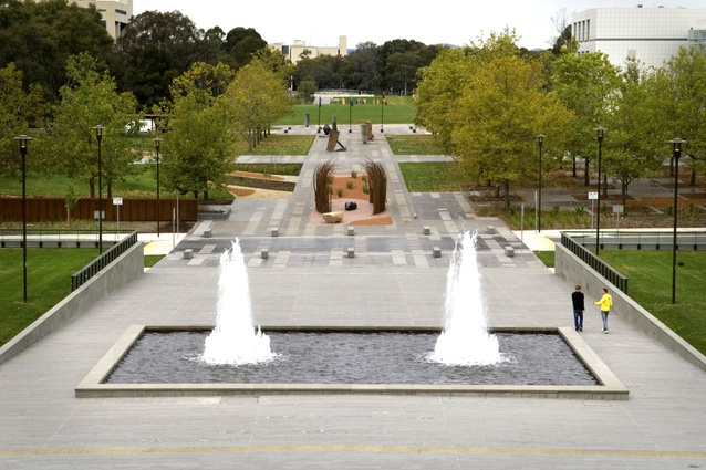 The campus and Reconciliation Place viewed from the NLA podium. Questacon is visible on the right and the NGA view corridor is revealed through the removal of Enid Lyons Street and transplanting of some 30 mature Plane Trees. The NLA water feature was restored to match its former glory.