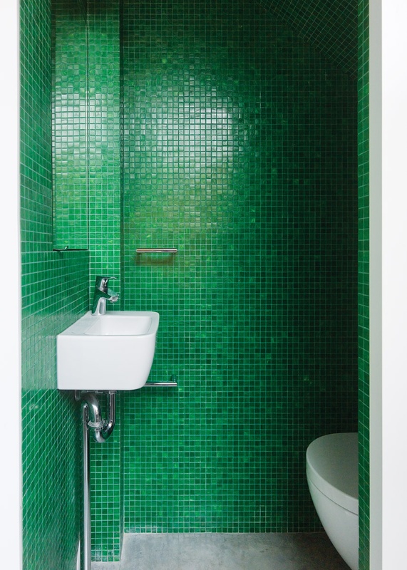 Bright green glass mosaic tiles line the second bathroom.