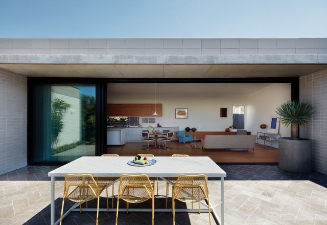 Primary living spaces spill out onto a north-facing courtyard, ensuring access to daylight and ventilation. Artwork (L-R): Rosalie Gascoigne; Michael Rose; Yves Klein. Styling: Alicia Sciberras.