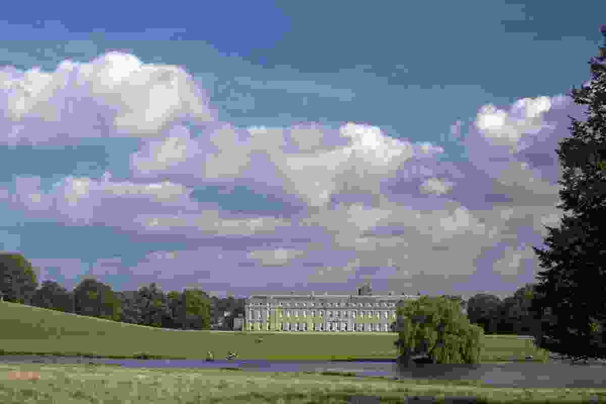 The west front of the late 17th century Petworth House, West Sussex, seen across Brown’s lake and park.