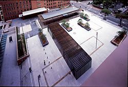  The public square by EDAW, as seen from the Justice Building. Timber markers show the location of heritage structures and the site’s archaeology has been retained and housed within a glass, timber and steel pavilion, also by Bates Smart. Image: Tyrone Branigan 