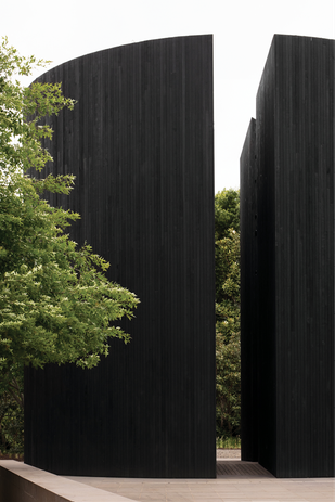 The two monolithic chambers are exactly mirrored, symmetrical in shape and proportion.