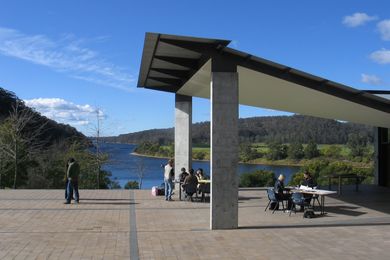 Participants on the annual Glenn Murcutt International Master Class working outside at the Boyd Education Centre overlooking the Shoalhaven River.