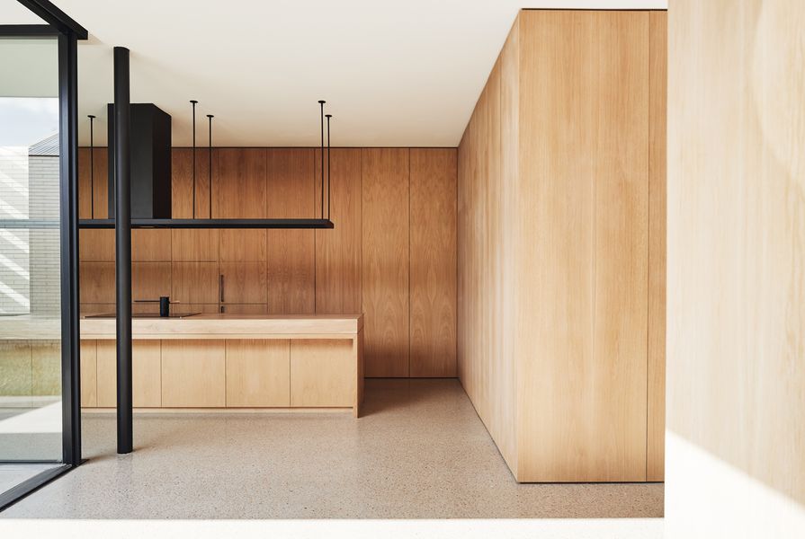 Behind a wall of American oak cabinetry is a four-metre benchtop and bar used for large gatherings.