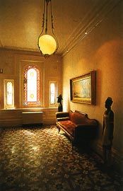 The white painted hallways, furnished to reflect the owners’ eclectic tastes.
