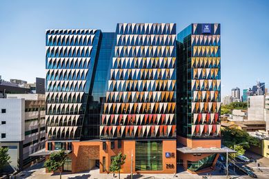The prism-shaped panels on the main tower facade respond to environmental conditions and form part of the precinct’s comprehensive sustainability strategy.