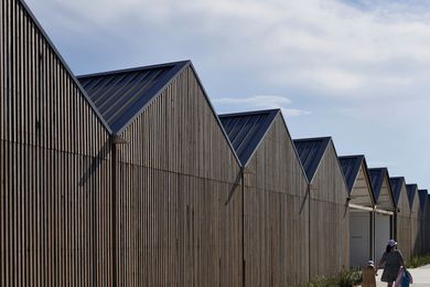 Turpentine timber salvaged from the original building forms the boathouse’s open-batten facade.