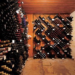 The wine cellar hidden beneath a closet.