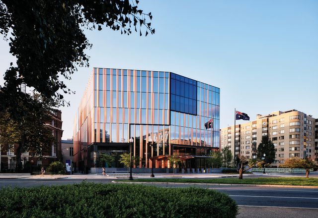 The facade’s tinted glass reflects the surroundings, while vertical panels evoke a eucalypt forest.