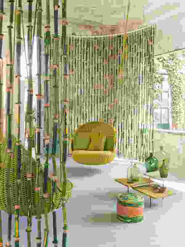 Bamboo partition, Orbitry suspended seat and Cerchi side tables by Paola Lenti.