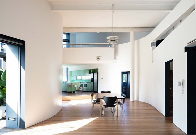 The apartment’s main living space bends with the arc of the crescent-shaped roof terrace.