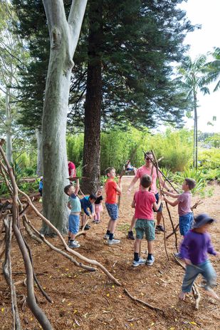 Children craft shelters from branches at the Ian Potter Children's Wild Play Garden.