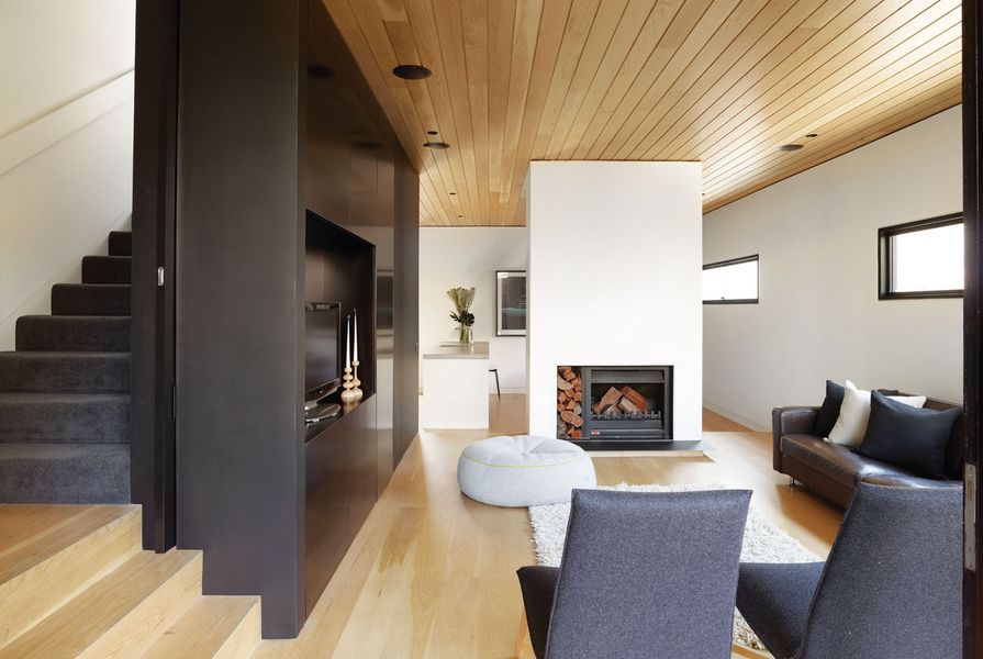 American oak flooring has been paired with ceiling lining boards that stretch from inside to out.