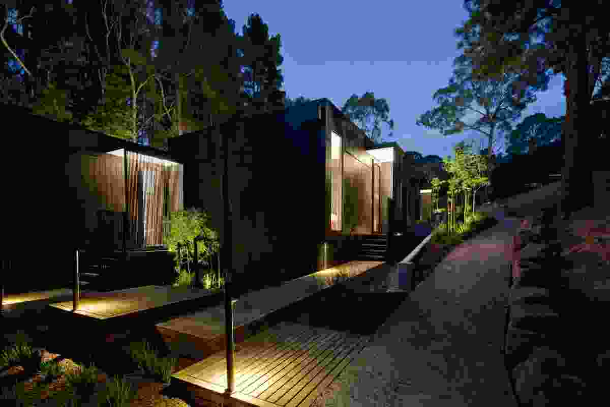 A series of interlocking duplexes clad in black-stained timber.