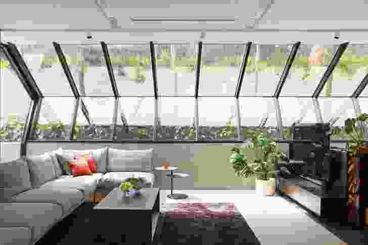 Angled windows in the living room look up to a sliver of rainforest garden and catch morning sun from the east.