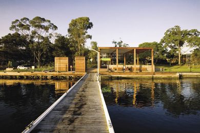 The generous shade structure opens out onto the lake swimming pool.