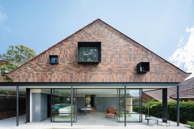 The rear elevation of the addition comprises a “suspended brick tapestry” over a lightweight pavilion.