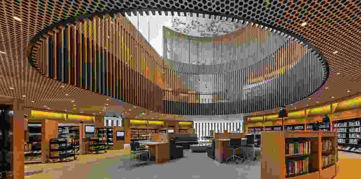 The library’s five floor levels are connected by a three-storey void, which is clad in vertical timber fins.