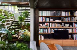 The lounge area sits slightly below the garden level and blurs perceptions of inside and out.