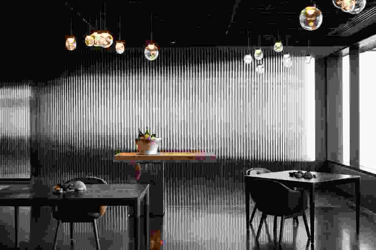 The dining room is silver and black and lit by hand-blown lights by Melbourne artist Emma Lashmar.