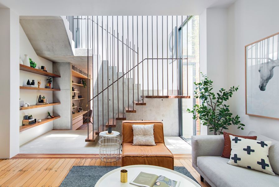 A new staircase in a central atrium marks the transition from old to new in a robust palette of concrete, recycled timber, steel and glass. Artwork: Maricou, Silver Mare.