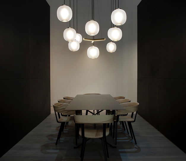 Resident's stand at Euroluce featuring Bloom pendants, Tri pendant, Odin chairs and Scholar table.