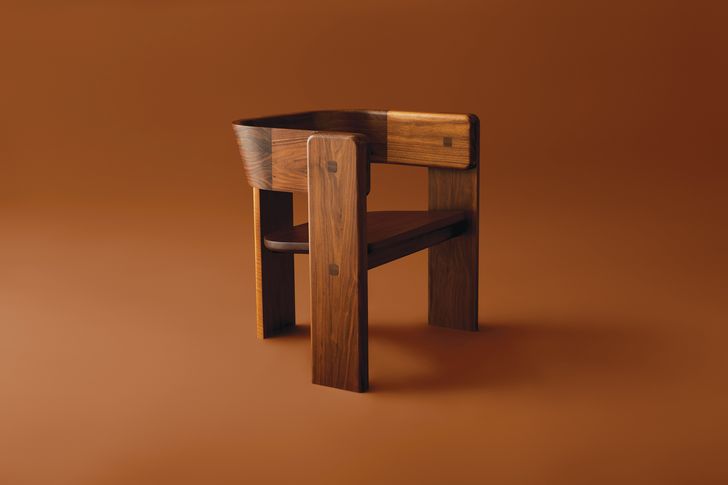 Crafted from solid timber, the Elle armchair possesses a strong, sculpted silhouette.