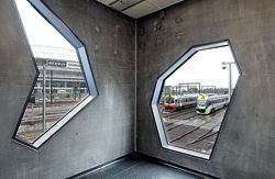 Irregularly shaped windows frame views of Melbourne’s
rail yards and
city skyline.