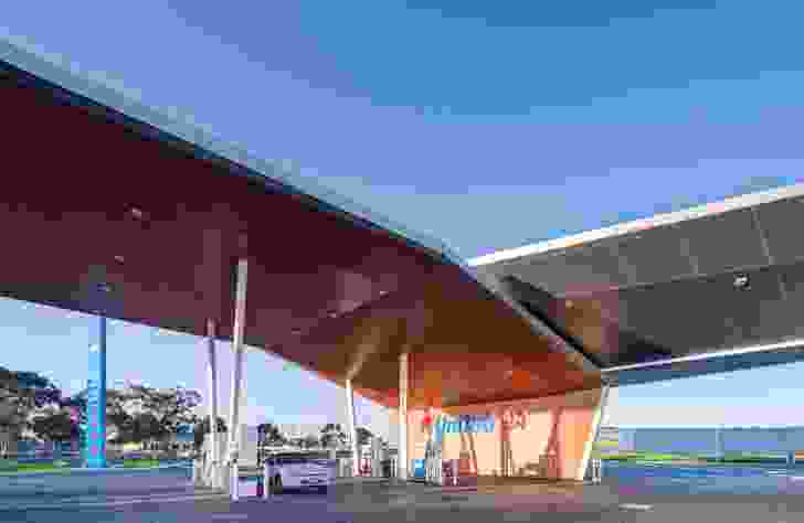 The eye-catching geometry of the service station is defined by two unfolding wings, forming blade-like canopies to the petrol bowsers.