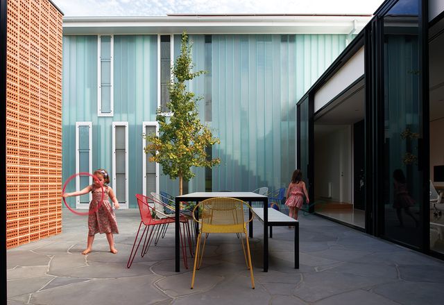 A central courtyard joins the old and new parts of the house and forms a primary activity zone for the family.