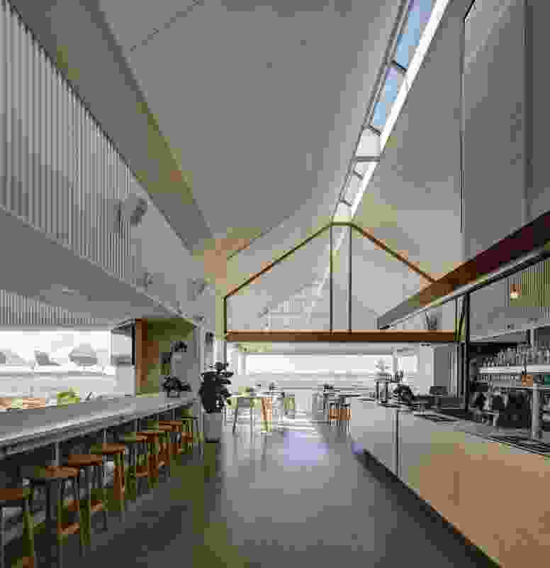 The main bar’s patterned walls and gabled vault are animated by changing sun shafts that enter through the linear skylight.