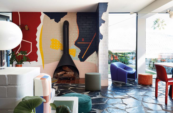 The expressive colour and material scheme, developed with Lymesmith, complements the original 1960s house. Mural: Lymesmith.