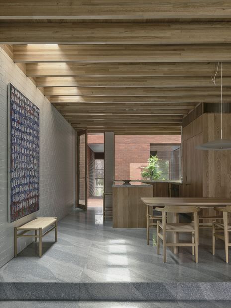 A stepped floor level separates dining and living zones. Artwork: Paul Partos.