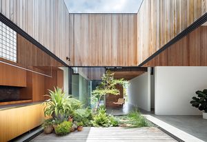 The central courtyard, lined with a landscaped garden, frames the sky and forms a pivot point around which daily life revolves.