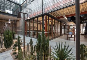 Giving off an opalescent shimmer, hand-cast Japanese glass blocks reference the site’s original use as a glass factory.