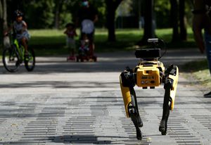 A robot dog called Spot patrols a Singapore park playing a recorded message telling people to observe physical distancing measures.