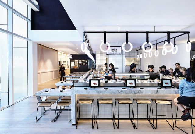 The design of the sushi train was inspired by subway stations. it features subway tiles and glowing led rings that are reminiscent of train handles.