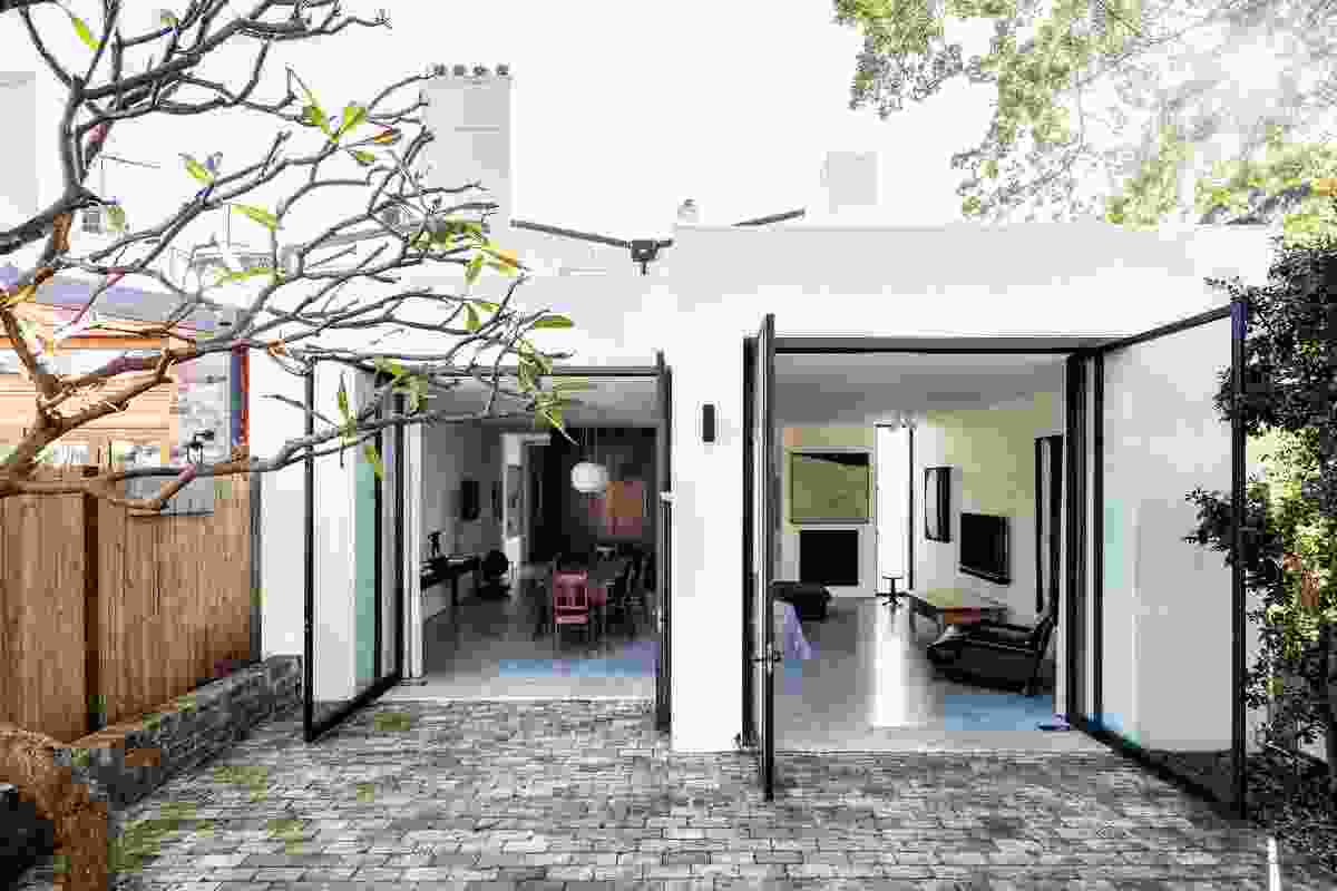 Comprising the kitchen, dining and living areas, the rear extension makes full use of the site. Artwork: Jo Bertini.