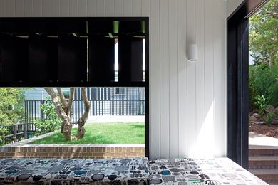 The deep reveals of the sitting room window frame the greenery beyond.