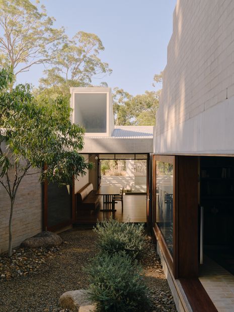 Two new brick volumes splay out from the existing cottage and define a private courtyard.