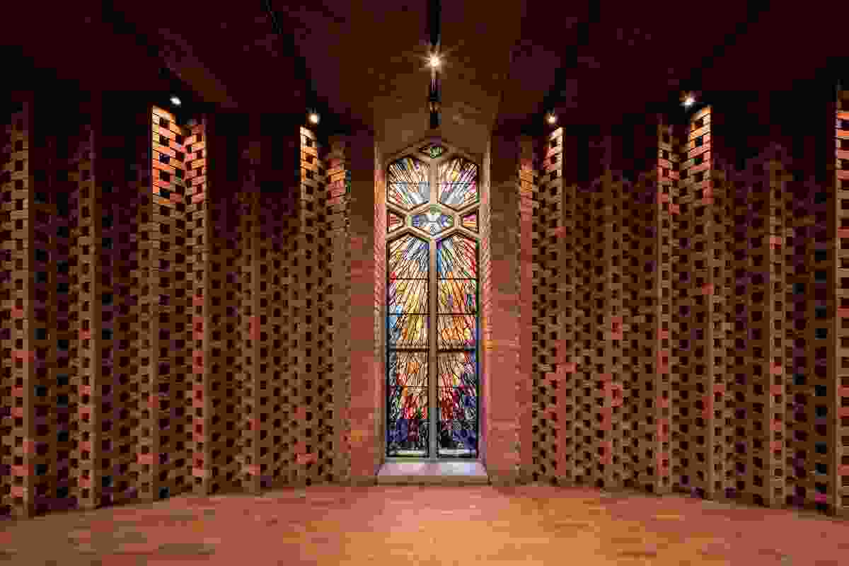 The folded brick screen behind the baptismal font incorporates a salvaged stained-glass window.