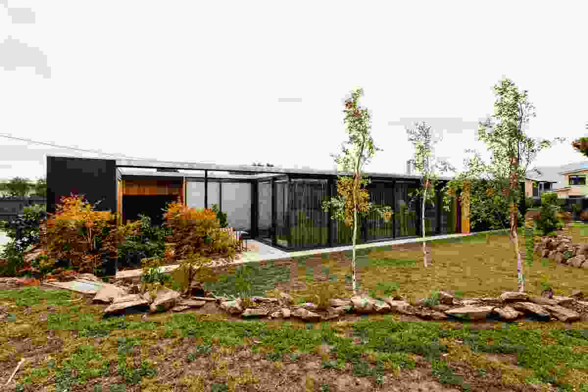 While the house is designed to merge with its landscape, it is also clearly delineated by black framing.