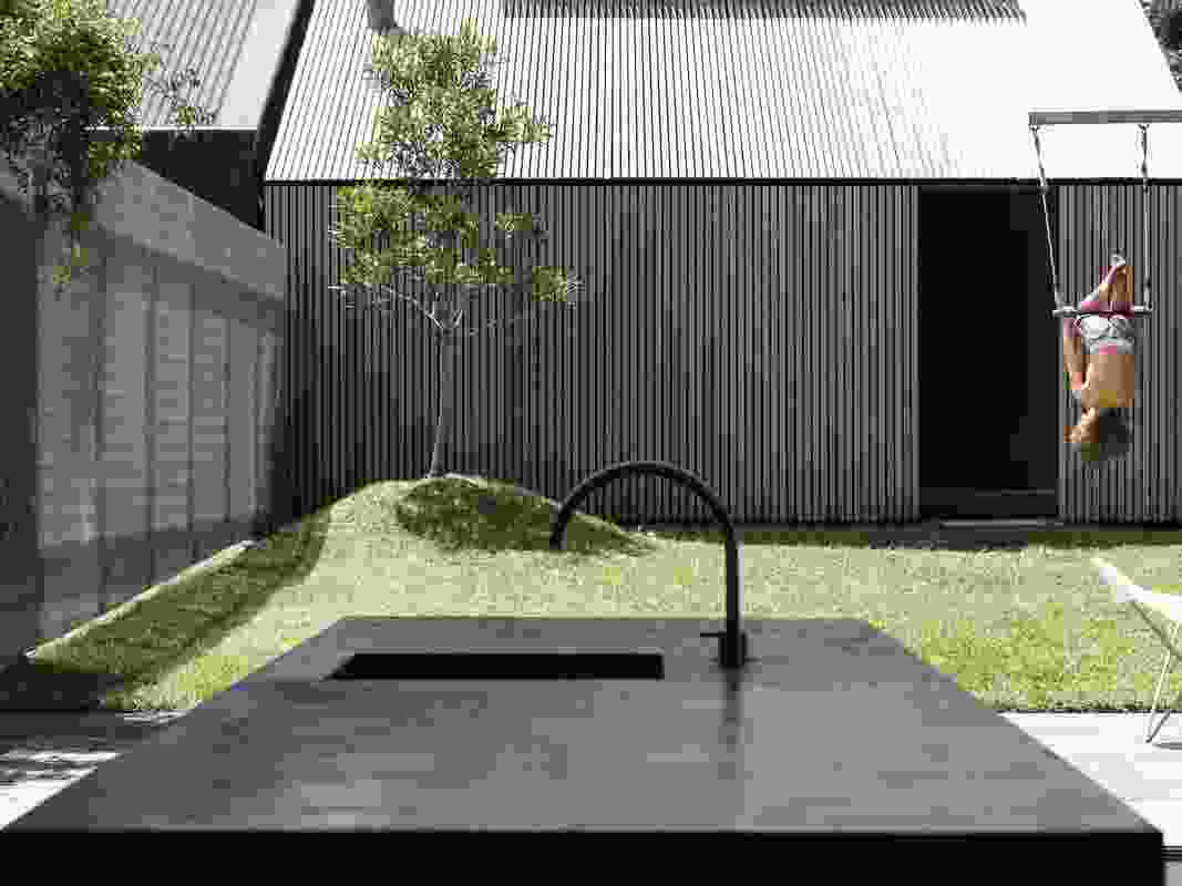 A separate garage/ studio bookends the site and the main garden sits between it and the home.