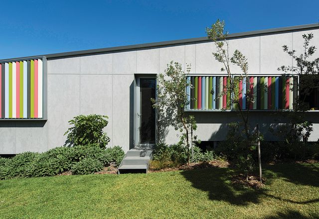 Vertical sun blades, in a fun palette of foliage-inspired colours, draw the garden into the fabric of the building.