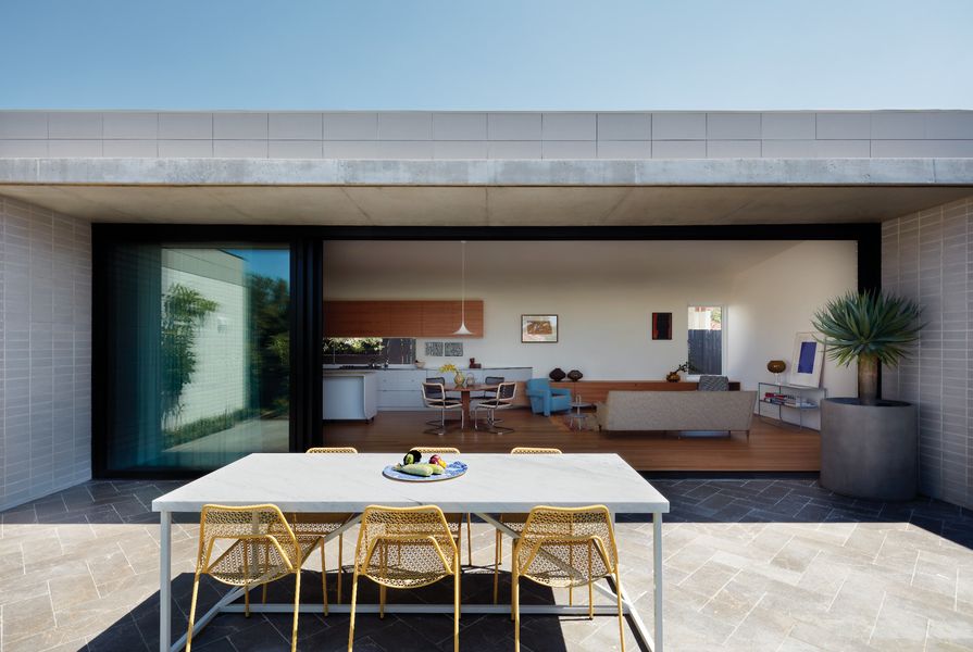 Primary living spaces spill out onto a north-facing courtyard, ensuring access to daylight and ventilation. Artwork (L-R): Rosalie Gascoigne; Michael Rose; Yves Klein. Styling: Alicia Sciberras.