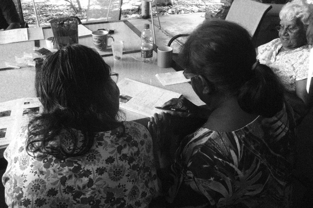Cissy Djiagween and Jane Augustine reviewing the report.
