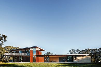 The main anchoring wall is rammed earth, Corten steel encases the stairwell, the first floor is clad in silvertop ash shiplap, while supports, balustrading and fascias are  galvanized steel.