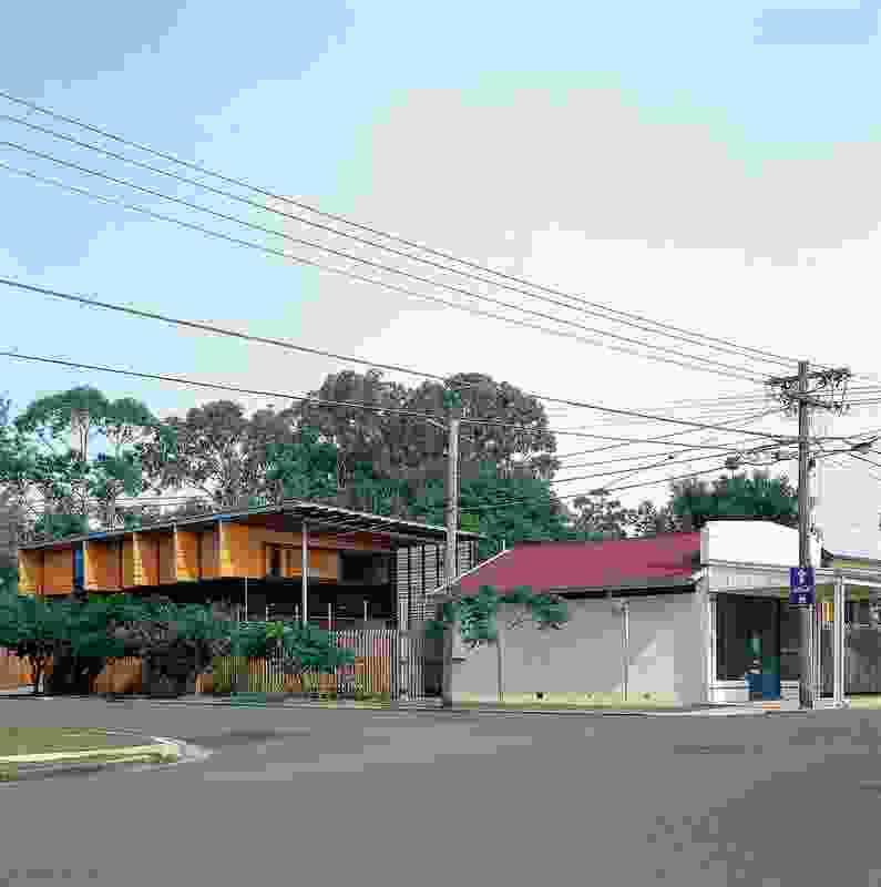 The house occupies a corner site in an older, timber-and-tin suburb of Brisbane.