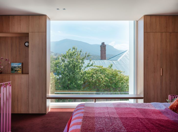 A full-height window in the new main bedroom on the upper level overlooks Kunanyi/Mount Wellington to the west.
