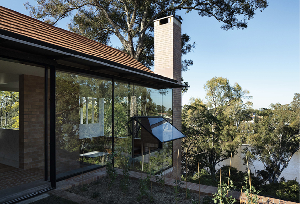The brick plinth of the existing cottage establishes a material logic that extends throughout.